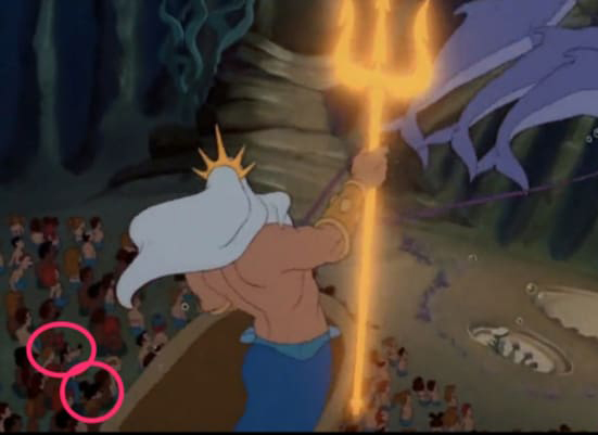 Mickey and Goofy in the crowd under King Triton